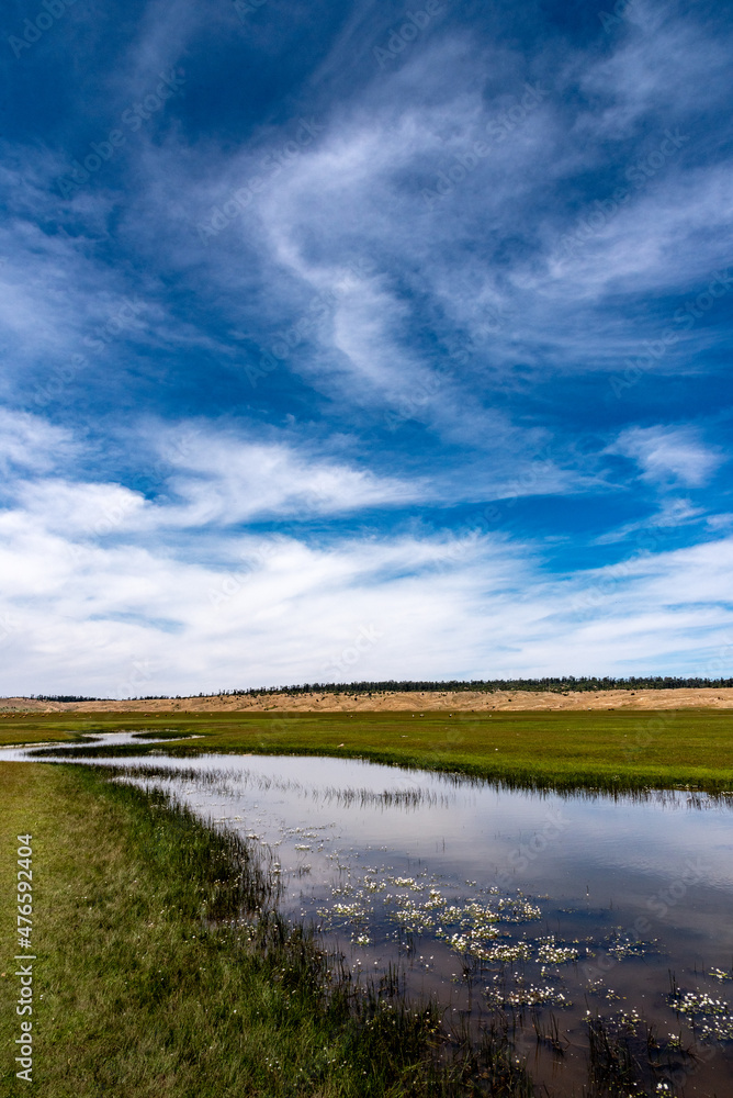 Lake Afnourir in Morocco. The sky is reflected in the still waters of a swampy area of the lake