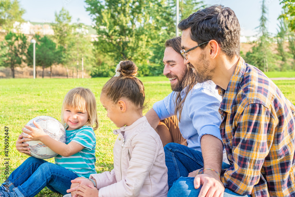 gay male couple with their children having a good time gay male couple with their children having a good time