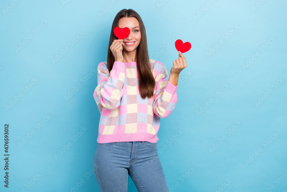 Photo of funny coquette lady hold two little hearts cover eye wear casual clothes isolated blue color background Photo of funny coquette lady hold two little hearts cover eye wear casual clothes isolated blue color background
