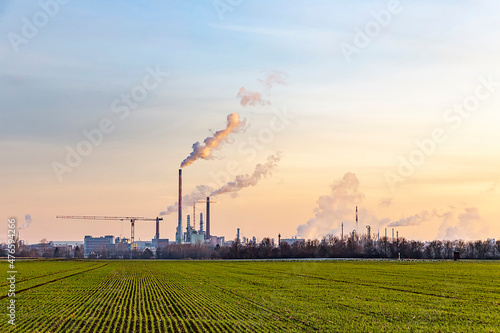 Billede på lærred industry complex in Frankfurt in late evening with  fields and smoking chimney