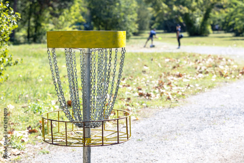 People playing flying disc golf sport game in the park