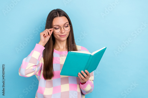 Photo of clever lady read book enjoy study new subject lesson wear specs sweater isolated blue color background