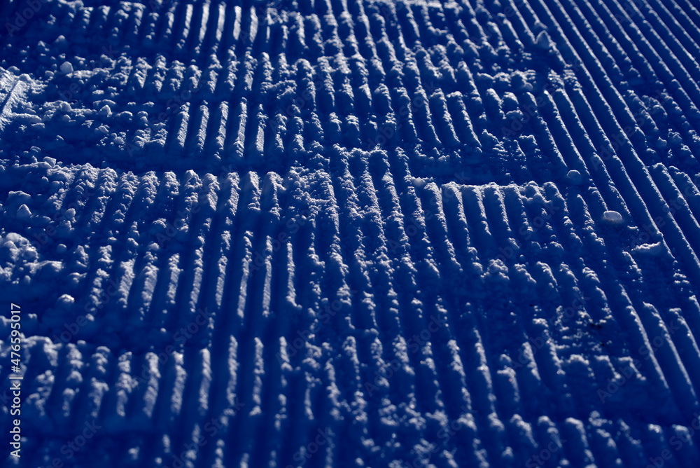 Fototapeta premium Close-up of pattern in the snow after reparation of slope by snowcat at mountain village Stoos, Canton Schwyz, on a sunny winter day. Photo taken December 20th, 2021, Stoos, Switzerland.