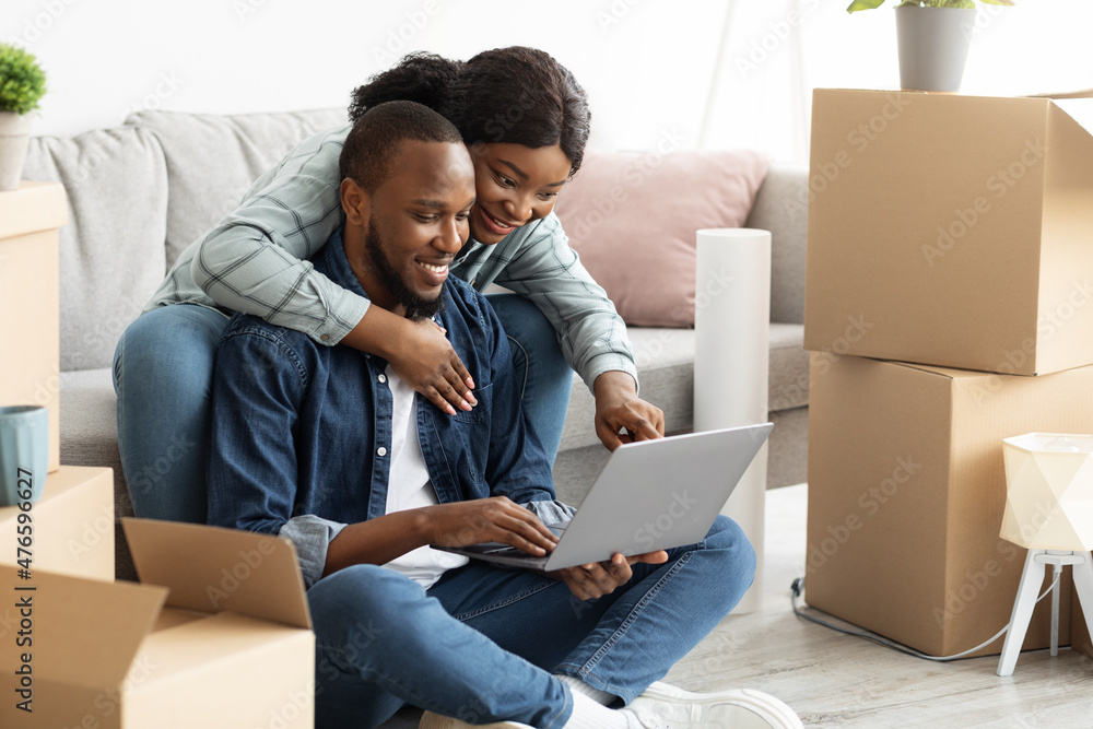 Online Order. Happy Young Black Couple With Laptop Choosing Furniture In Internet Online Order. Happy Young Black Couple With Laptop Choosing Furniture In Internet