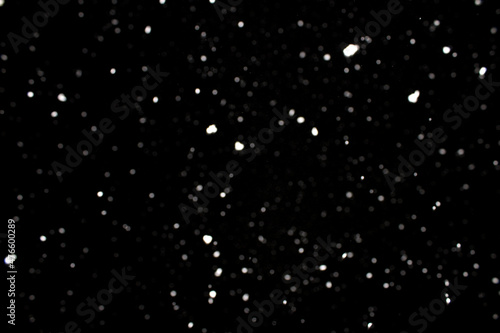Falling snowflakes on black background, snowing at night, snow flakes fall 