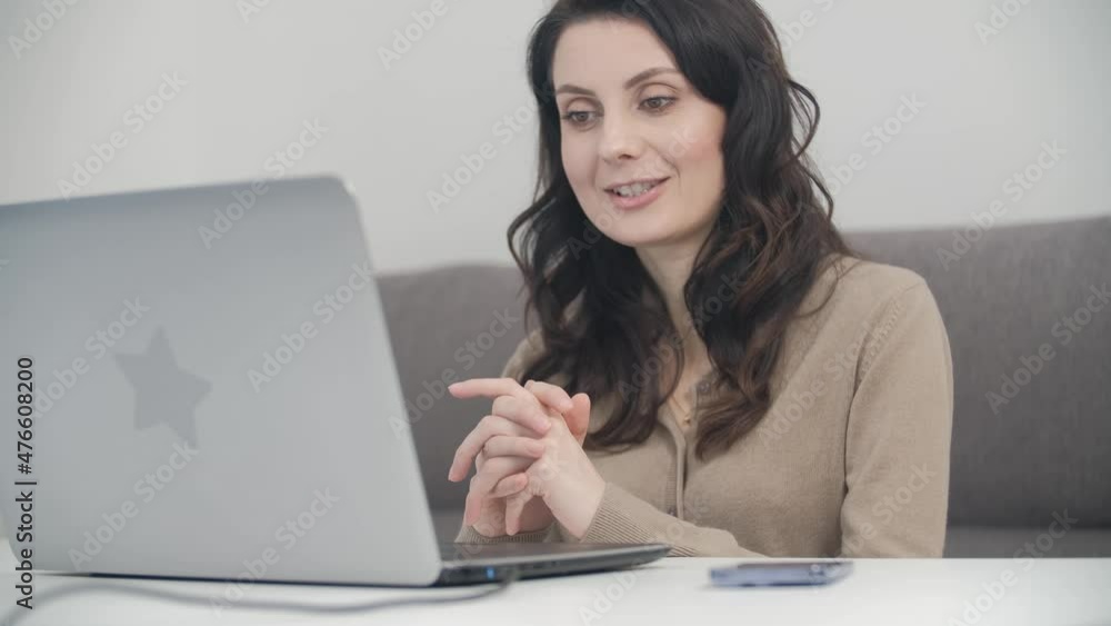 Distance education and teaching online concept. Young woman in late 30s teaches students on conference video call Distance education and teaching online concept. Young woman in late 30s teaches students on conference video call
