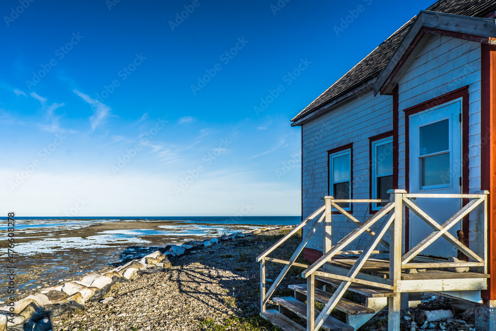 View on the lighthouse keeper's house and the shoreline in Pointe Ouest on Anticosti island, in Cote Nord region of Quebec, Canada View on the lighthouse keeper's house and the shoreline in Pointe Ouest on Anticosti island, in Cote Nord region of Quebec, Canada
