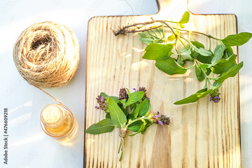 Prunella vulgaris, self-heal, heal-all, plant with root and fresh heart-of-the-earth, carpenter's herb, brownwort and blue curls on cutting board. herb for cosmetology and alternative medicine Prunella vulgaris, self-heal, heal-all, plant with root and fresh heart-of-the-earth, carpenter's herb, brownwort and blue curls on cutting board. herb for cosmetology and alternative medicine