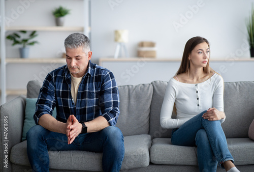 Depressed mature man and woman having relationship problems, going through marital crisis at home photo