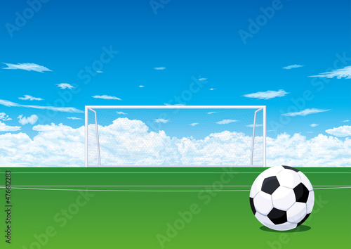 ピッチのサッカーボールとゴールと青空