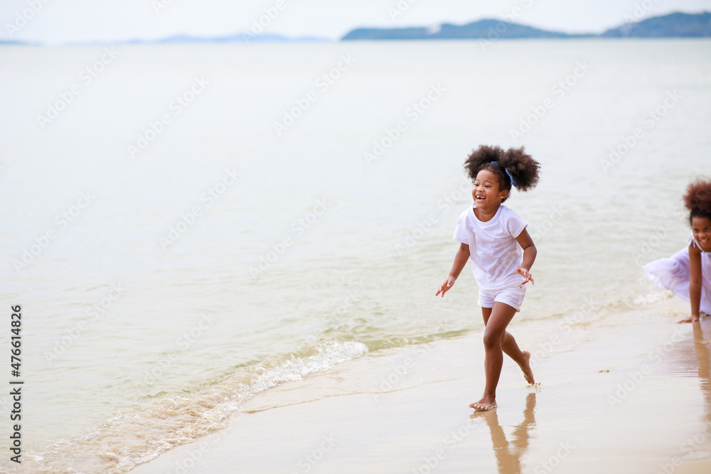 Two African girl playing on the beach during holiday. Two African girl playing on the beach during holiday.