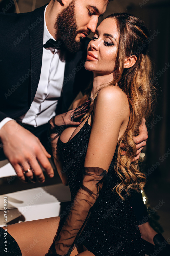 The guy gently hugs his girlfriend. A loving young couple on New Year's Eve. Close-up. The guy gently hugs his girlfriend. A loving young couple on New Year's Eve. Close-up.