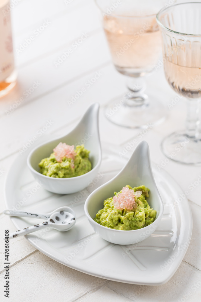 Fresh guacamole with caviar lime (Australian finger lime) fruits and rose sparkling wine Fresh guacamole with caviar lime (Australian finger lime) fruits and rose sparkling wine