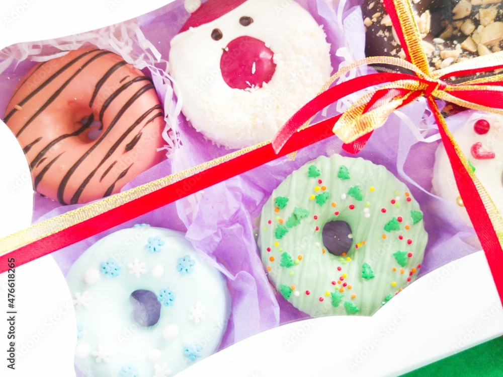 christmas donut box, donuts with icing and sprinkles	