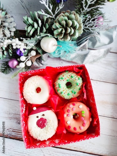 christmas donut box, donuts with icing and sprinkles	