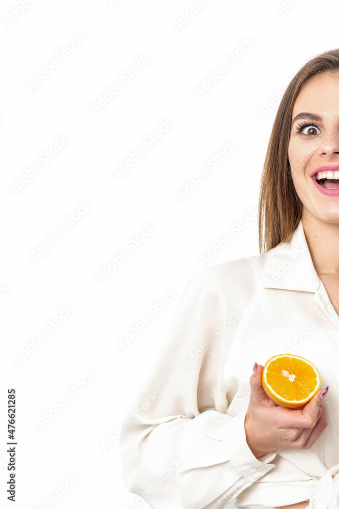 Joyful attractive young woman having piece of orange isolated on white background with copy space Joyful attractive young woman having piece of orange isolated on white background with copy space