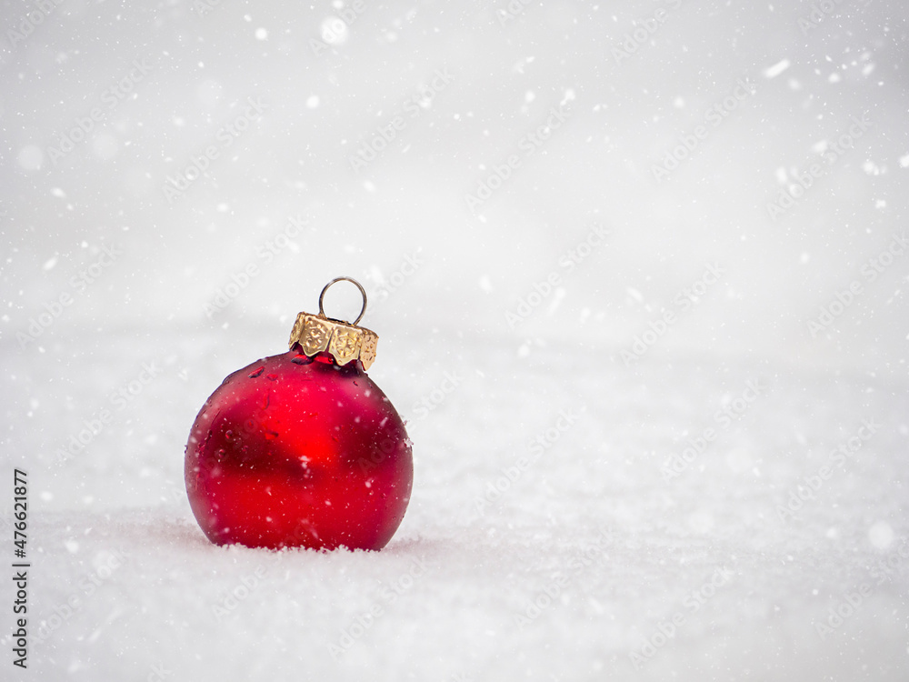 Red Glass Ball in the Snow. Holiday Background. Red Glass Ball in the Snow. Holiday Background.