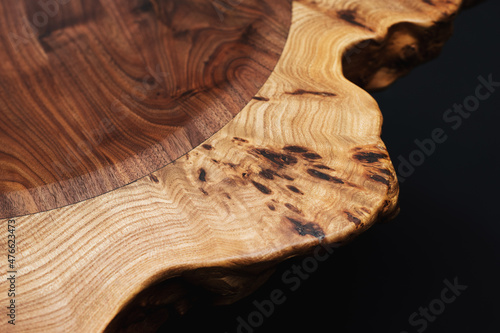 Style wooden countertop slab, saw cut wood treated with varnish close-up on black Fotobehang