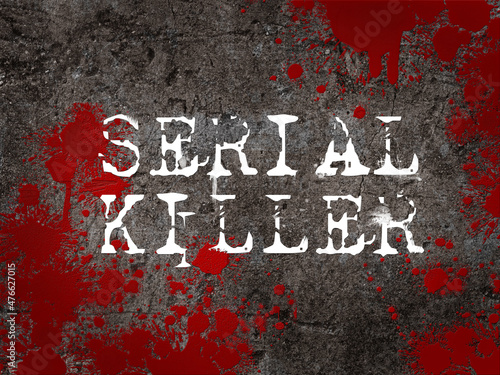 The word serial killer against a concrete floor splattered with blood. Criminal investigation case title. photo