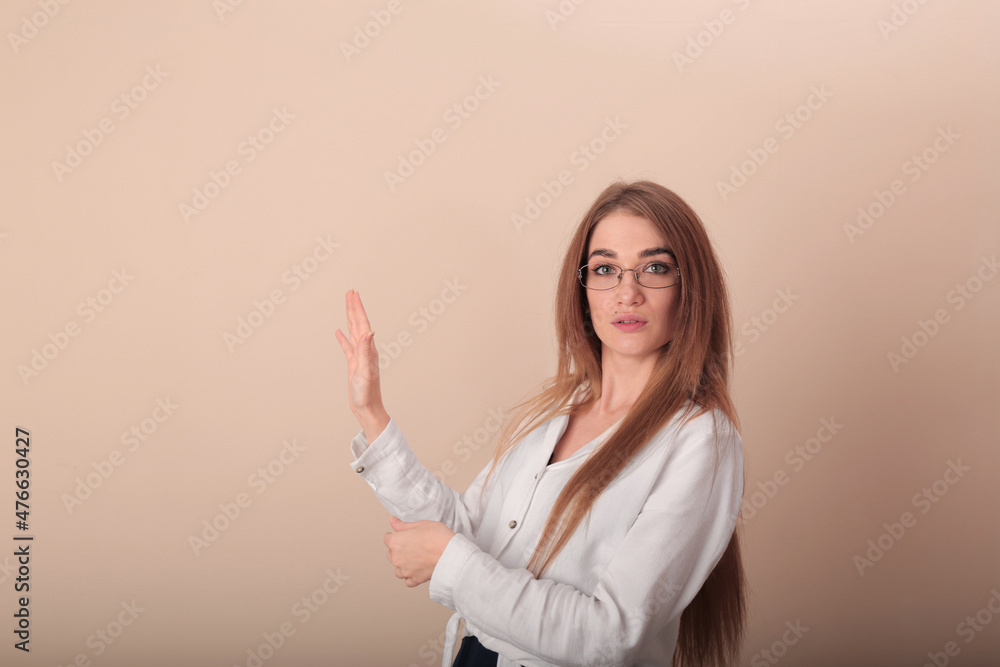 young beautiful girl in the image of a teacher. in glasses and a white blouse. stands half sideways. looking at the camera young beautiful girl in the image of a teacher. in glasses and a white blouse. stands half sideways. looking at the camera