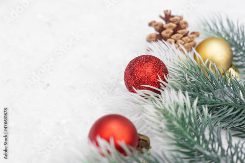 Christmas composition of Christmas tree toy red and gold ball snow background tree branch cone