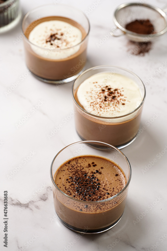Italian chocolate and coffee mousse dessert semifreddo - half-frozen ice cream with whipped cream and cocoa powder in small glasses Italian chocolate and coffee mousse dessert semifreddo - half-frozen ice cream with whipped cream and cocoa powder in small glasses