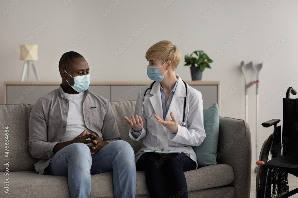 Covid-19, medical consultation with smiling mature lady doctor in coat gestures, explains result examination Covid-19, medical consultation with smiling mature lady doctor in coat gestures, explains result examination