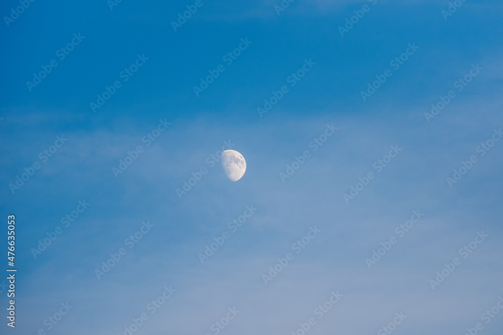 White moon in the evening blue sky. Copy space. White moon in the evening blue sky. Copy space.