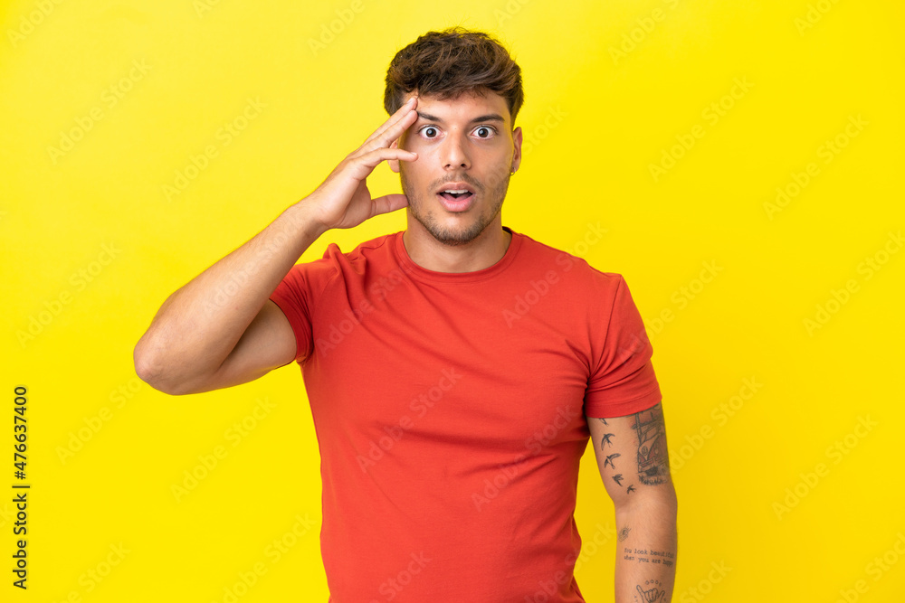 Young caucasian handsome man isolated on yellow background has realized something and intending the solution Young caucasian handsome man isolated on yellow background has realized something and intending the solution