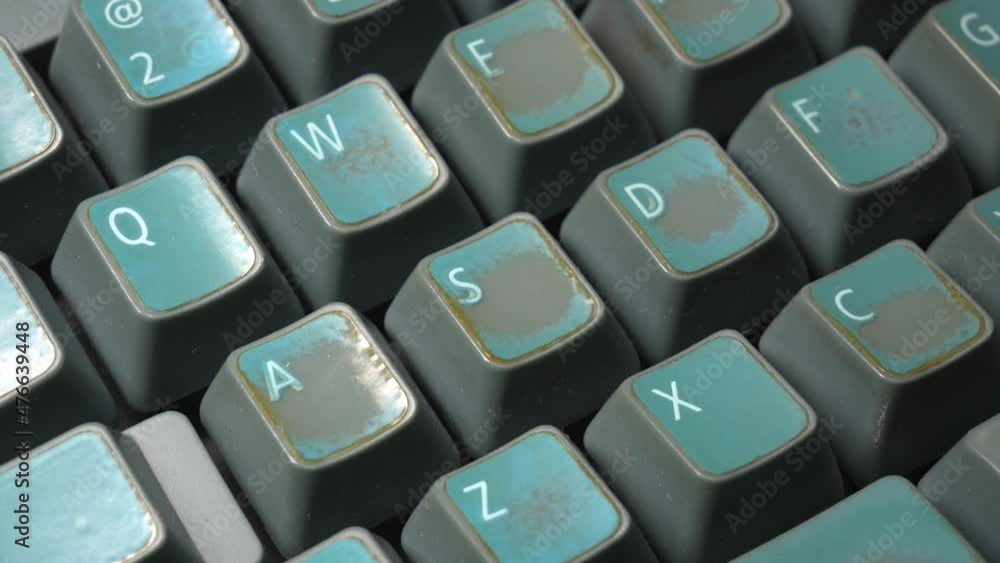 WASD keys on a vintage old faded worn mechanical desktop PC keyboard