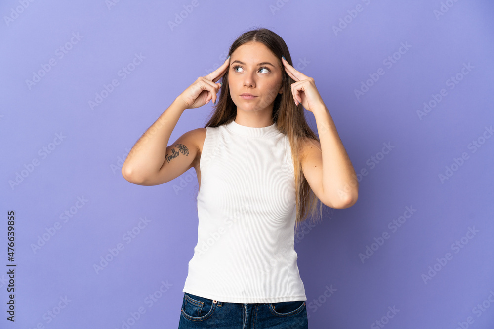 Young Lithuanian woman isolated on purple background having doubts and thinking Young Lithuanian woman isolated on purple background having doubts and thinking