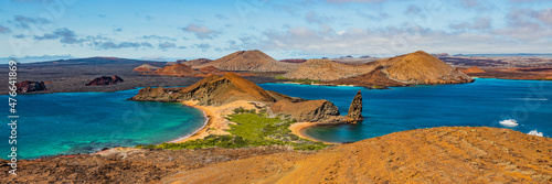 Galapagos islands travel banner. Bartolome Island, volcanic islet in the Islas Galapagos archipelago. Panoramic view of Sullivan bay, golden beach and Santiago island from hiking on cruise excursion.