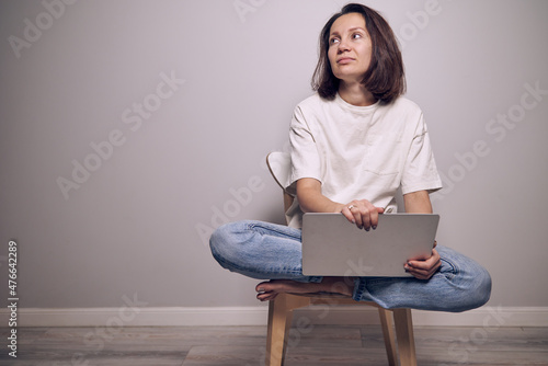 woman sitting on a chair with laptop