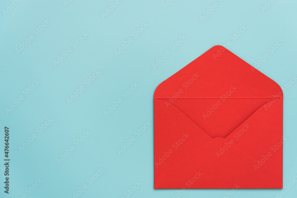 An open red envelope on a blue background. There's room for text. Stylish Valentine's Day card. Declaration of love. Invitation to a wedding, birthday or Christina. Passionate love. An open red envelope on a blue background. There's room for text. Stylish Valentine's Day card. Declaration of love. Invitation to a wedding, birthday or Christina. Passionate love.