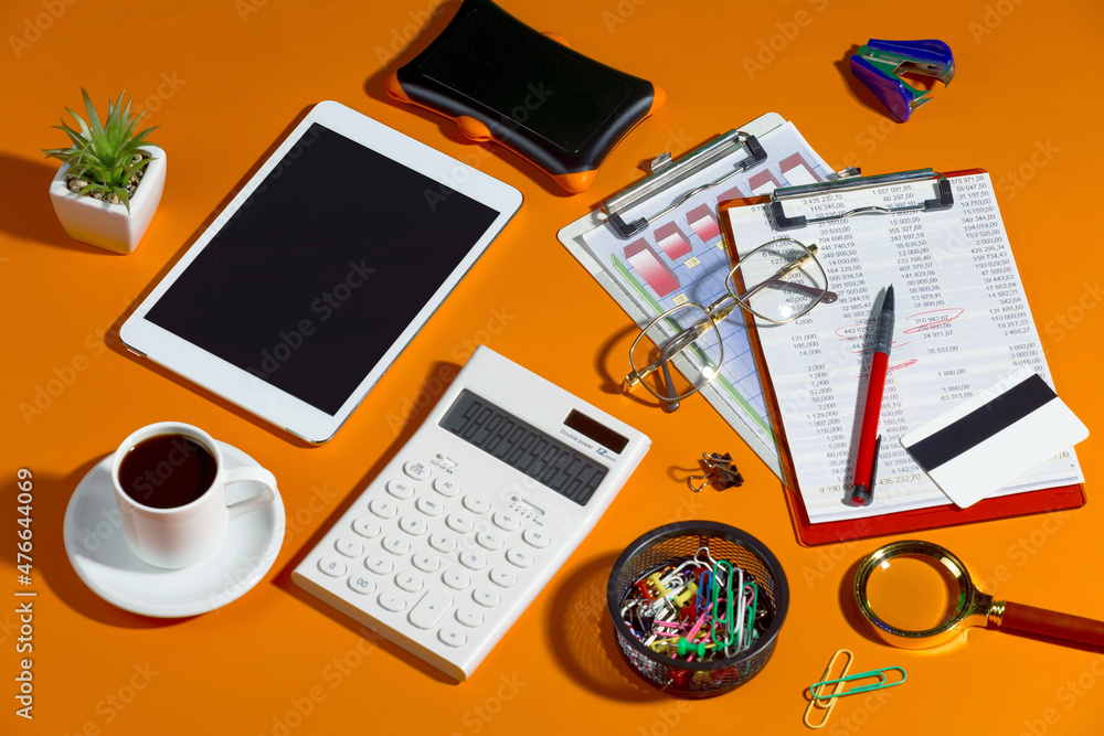 Fototapeta premium Business items in the office, laid out in a composition on a bright, colorful background. Top view.