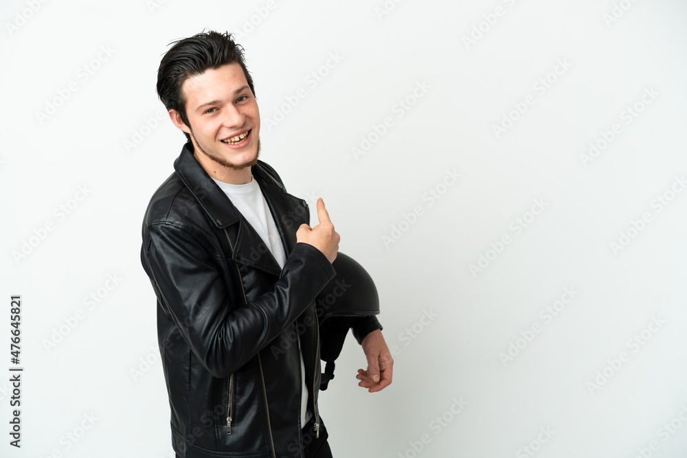 Russian man with a motorcycle helmet isolated on white background pointing back Russian man with a motorcycle helmet isolated on white background pointing back