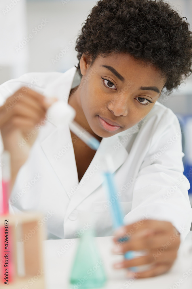 woman chemist making a mixture woman chemist making a mixture