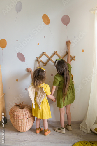 girls have fun in the nursery. creative cozy interior of the nursery. interior wall stickers