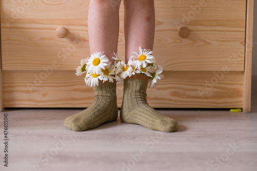 flowers in socks. daisies in socks for a little girl. cozy photo