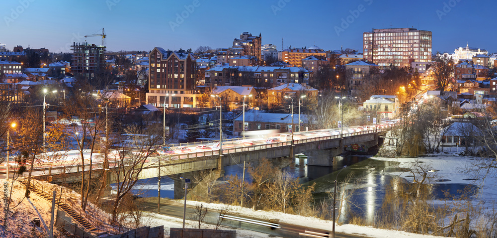 Naklejka premium Vinnytsia, Ukraine. Night winter city view from the river Southern Bug in the city of Vinnitsa to the central part in winter time. City center view