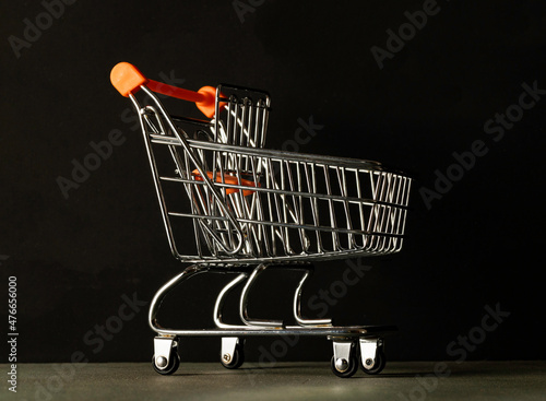 Shopping cart, photographed against a dark background.