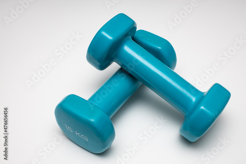 two small and light dumbbells lie on a white background