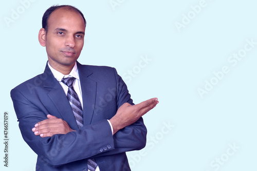 Young smiling Indian businessman pointing with finger upward image