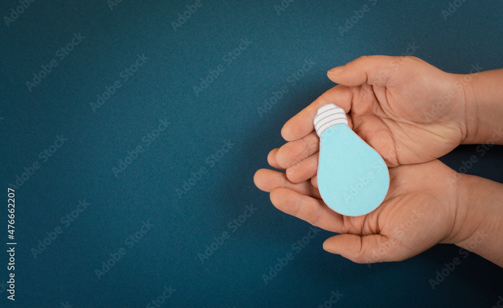 Holding a light bulb in the palm of the hand, creative concept, having new ideas, brainstorming for strategy, start up business Holding a light bulb in the palm of the hand, creative concept, having new ideas, brainstorming for strategy, start up business