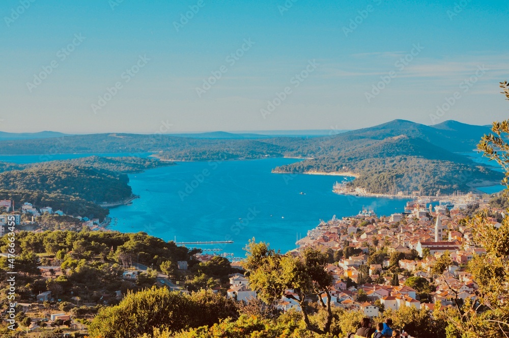 Panoramic view to the city and port of Mali Losinj. Island Losinj blue lagoon with Osorcica mountain in background. Adriatic Sea.Buildings and houses.