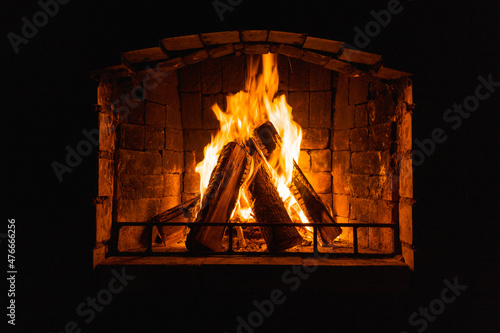 Glowing fire in home stone fireplace
