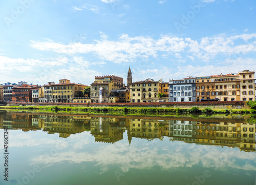 view of Florence`s buildings reflected in the waters of Arno River - Florence, Italy