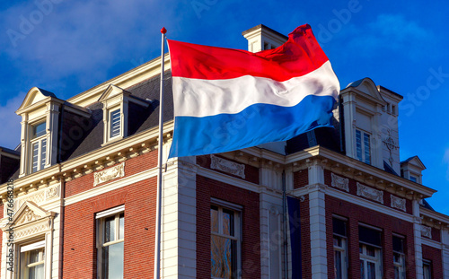 Netherlands. State national flag against a blue sky .