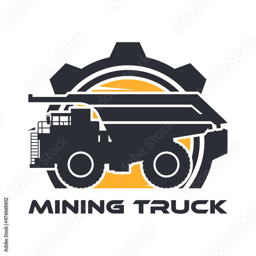 Heavy machinery label with mining truck silhouette and gear over bright sun