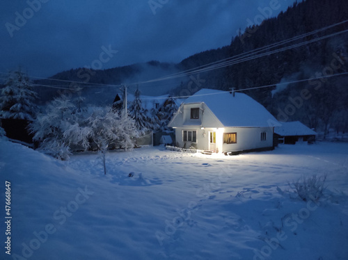winter evening in village synevir glade. ukraine